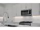 Close-up of a modern kitchen featuring stainless steel appliances and white subway tile backsplash at 180 Eagleston Ln, Lakewood Ranch, FL 34240