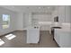 Bright, modern kitchen with an island, white cabinets, and stainless steel appliances at 180 Eagleston Ln, Lakewood Ranch, FL 34240