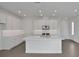 Modern kitchen with white cabinets, quartz countertops, and stainless steel appliances at 180 Eagleston Ln, Lakewood Ranch, FL 34240