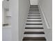 Staircase with wood treads and white risers, railing, and stringer at 180 Eagleston Ln, Lakewood Ranch, FL 34240