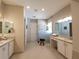 Large bathroom with double vanity, walk-in shower, and plenty of counter space at 5013 Sevilla Shores Dr, Wimauma, FL 33598