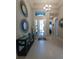 Bright and spacious entryway with tile flooring and decorative mirrors at 5013 Sevilla Shores Dr, Wimauma, FL 33598