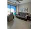 Home office with comfortable futon, desk, and wall of awards at 5013 Sevilla Shores Dr, Wimauma, FL 33598