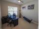 Bright home office features a large window, built-in desk, and plenty of space at 5013 Sevilla Shores Dr, Wimauma, FL 33598