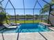 Inviting pool with a spa and a screened enclosure at 5013 Sevilla Shores Dr, Wimauma, FL 33598