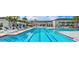 Relaxing resort-style pool with lounge chairs and shaded areas at 5013 Sevilla Shores Dr, Wimauma, FL 33598