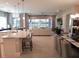 Open concept kitchen, living, and dining area with view of backyard at 5013 Sevilla Shores Dr, Wimauma, FL 33598