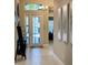 Light and airy entryway, featuring a modern console table and artwork at 5013 Sevilla Shores Dr, Wimauma, FL 33598