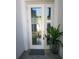 Inviting front door entry with glass panels and modern design at 5013 Sevilla Shores Dr, Wimauma, FL 33598