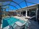 Inviting pool area with covered patio, lounge chairs, and a spacious pool at 5013 Sevilla Shores Dr, Wimauma, FL 33598