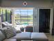 Relaxing living area showcasing a sectional sofa and stunning pool views at 5013 Sevilla Shores Dr, Wimauma, FL 33598