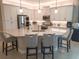 Modern kitchen with white cabinets, quartz countertops, and stainless steel appliances at 5013 Sevilla Shores Dr, Wimauma, FL 33598