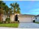 Two-story home with attached garage and landscaping at 5013 Sevilla Shores Dr, Wimauma, FL 33598