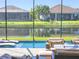 Relaxing pool area with screened enclosure and lake view at 5013 Sevilla Shores Dr, Wimauma, FL 33598