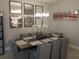 Elegant dining room with large table, chandelier, and modern wall art at 5013 Sevilla Shores Dr, Wimauma, FL 33598