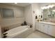 Spa-like bathroom featuring a soaking tub and double vanity at 5013 Sevilla Shores Dr, Wimauma, FL 33598