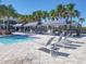 Large resort-style pool with multiple cabanas and lounge chairs at 5013 Sevilla Shores Dr, Wimauma, FL 33598