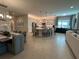 Open concept kitchen with large island, flows into living and dining areas at 5013 Sevilla Shores Dr, Wimauma, FL 33598