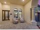 Inviting entryway with wicker seating and arched windows at 5704 Arnie Loop, Lakewood Ranch, FL 34211