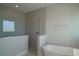 Modern bathroom with glass-enclosed shower and soaking tub at 17434 Crisp Apple Ln, Land O Lakes, FL 34638