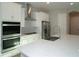 Bright kitchen with stainless steel appliances and a large center island at 17434 Crisp Apple Ln, Land O Lakes, FL 34638