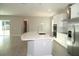 Open kitchen and living space with a center island and modern appliances at 17434 Crisp Apple Ln, Land O Lakes, FL 34638