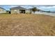 Large backyard with dormant grass and white fence at 30854 Water Lily Dr, Brooksville, FL 34602