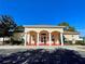 Community clubhouse with columns and a red tiled entryway at 30854 Water Lily Dr, Brooksville, FL 34602