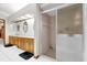 Bathroom featuring double vanities, a shower, and tiled floor at 26142 Mountainview Blvd, Brooksville, FL 34602