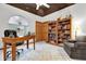 Home office with a desk, bookcase, comfortable chair, and a unique galaxy-painted ceiling at 26142 Mountainview Blvd, Brooksville, FL 34602