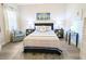 Bedroom with a queen bed, sitting chair, and coastal decor at 1241 Riverscape St, Bradenton, FL 34208