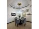 Cozy dining room featuring a glass table, upholstered chairs, and elegant wall art at 1241 Riverscape St, Bradenton, FL 34208