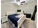 Bedroom with white bed frame, dresser and ceiling fan at 7231 Salt River Ave, Sun City Center, FL 33573