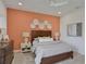 Bedroom featuring a full bed, dresser, and an accent wall with artwork at 7482 Sea Manatee St, Parrish, FL 34219