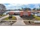 Bird's-eye view of a pink mid-century modern home with a spacious driveway and waterfront location at 351 Harbor Psge, Clearwater Beach, FL 33767
