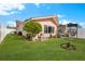 Landscaped backyard with grassy area, and partial view of pool and patio at 351 Harbor Psge, Clearwater Beach, FL 33767