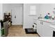 Laundry room includes storage and a sink, with an exterior door for easy access at 351 Harbor Psge, Clearwater Beach, FL 33767