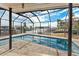 Relaxing screened pool area with canal views and patio seating at 351 Harbor Psge, Clearwater Beach, FL 33767