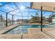 Inviting pool area with screened enclosure, offering water views at 351 Harbor Psge, Clearwater Beach, FL 33767