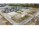 Aerial view of a residential community with modern homes, future home lots, and inviting ponds at 9019 Rothman Ln, Lakewood Ranch, FL 34240