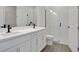 Bathroom with dual sinks, quartz countertops, tile flooring, and a glass shower at 9019 Rothman Ln, Lakewood Ranch, FL 34240