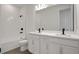 Bright bathroom features a double sink vanity, tub with shower, and modern finishes at 9019 Rothman Ln, Lakewood Ranch, FL 34240