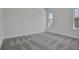 Spacious bedroom featuring carpet, white walls, and two large windows with ample natural light at 9019 Rothman Ln, Lakewood Ranch, FL 34240