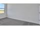 Empty bedroom with gray carpet, white walls, window, and natural light at 9019 Rothman Ln, Lakewood Ranch, FL 34240