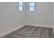 Clean, carpeted bedroom with two windows and fresh, neutral paint at 9019 Rothman Ln, Lakewood Ranch, FL 34240