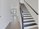 Bright entryway featuring modern staircase with black accents and beautiful wood-look flooring at 9019 Rothman Ln, Lakewood Ranch, FL 34240
