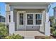 Close-up of front porch with white columns and a glass-paneled front door at 9019 Rothman Ln, Lakewood Ranch, FL 34240