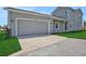 Side view of a two-car garage with a gray door and a well-kept lawn at 9019 Rothman Ln, Lakewood Ranch, FL 34240