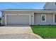 Spacious two car garage with a gray door and adjacent lawn at 9019 Rothman Ln, Lakewood Ranch, FL 34240