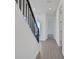 Hallway featuring wood-look flooring, dark railings and black newel posts at 9019 Rothman Ln, Lakewood Ranch, FL 34240